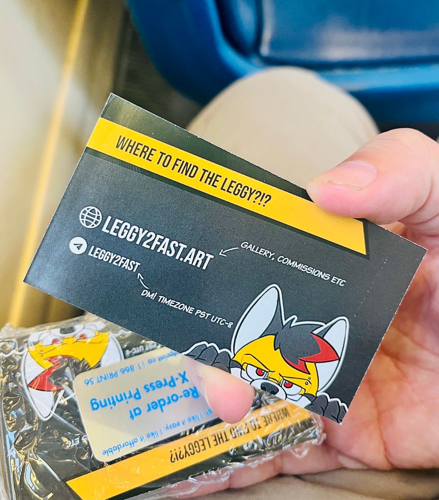 Picture of the back of a business card that says 'Where to find the Leggy' with a url leggy2fast.art and a telegram address 'Leggy2fast'. A peeker of Raf's fursona is on the bottom right corner.'