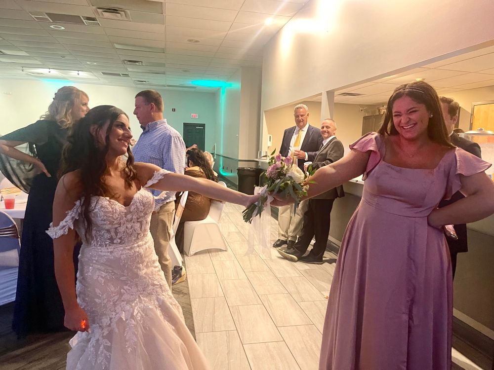 Liv getting handed a bouquet by her friend