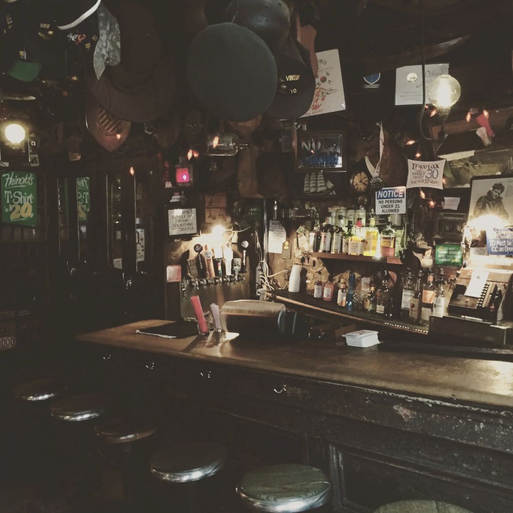 A tiny, old-timey wooden bar that is sloping downward at an almost alarming angle. Enough to be significantly noticeable, but not enough to stop you from settling down for a nice shot of bourbon.