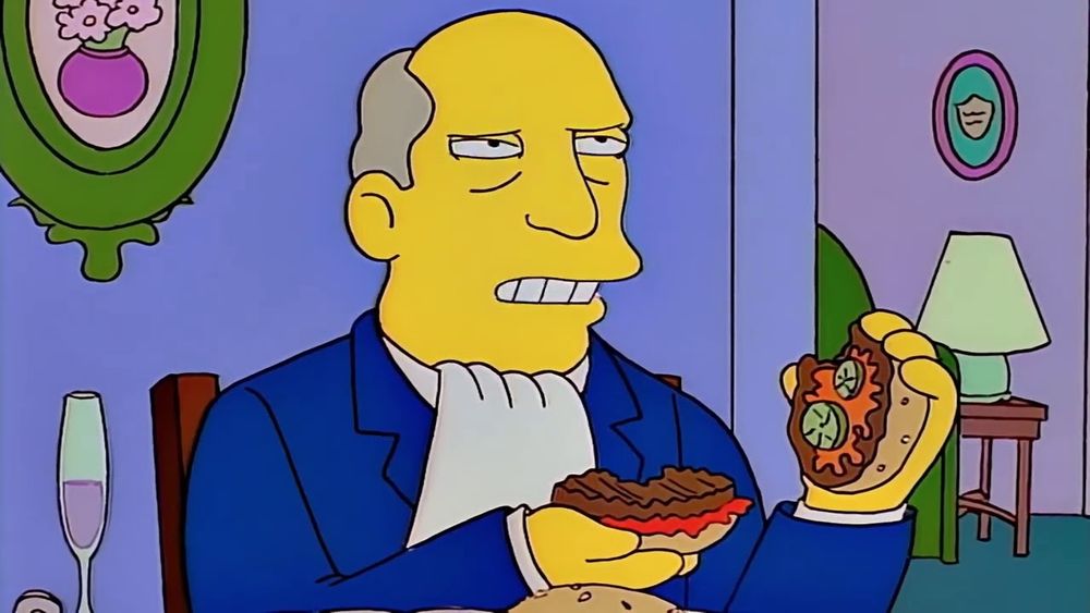 Simpsons superintendent Chalmers holding a burger looks dubious