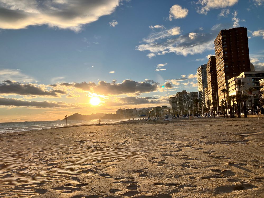 View of sea, skyscrapers and sky in Benidorm,Spain at golden hour.