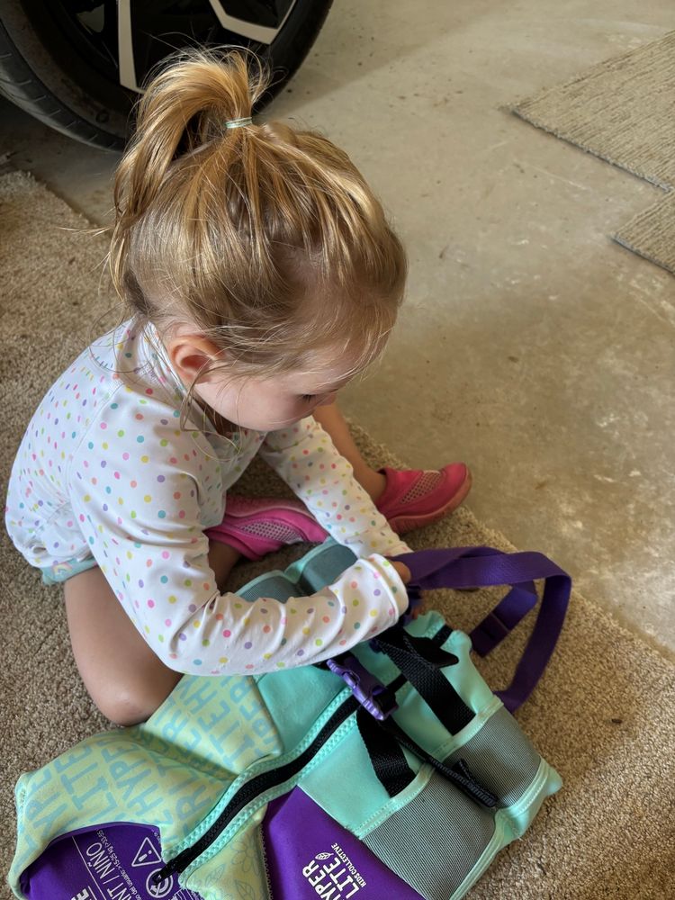My 2 year old buckling a life jacket 