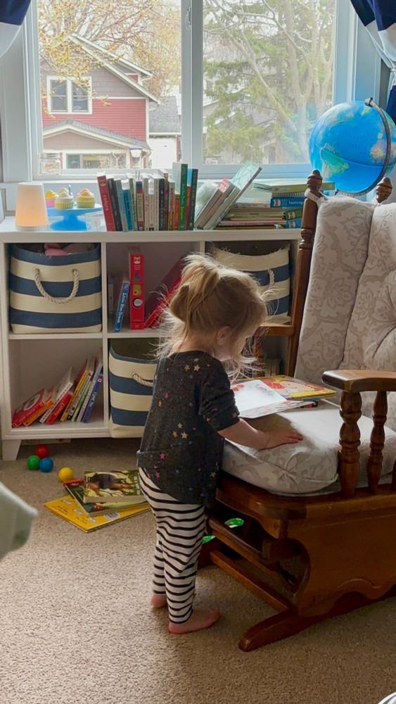 My toddler looking at a book by herself