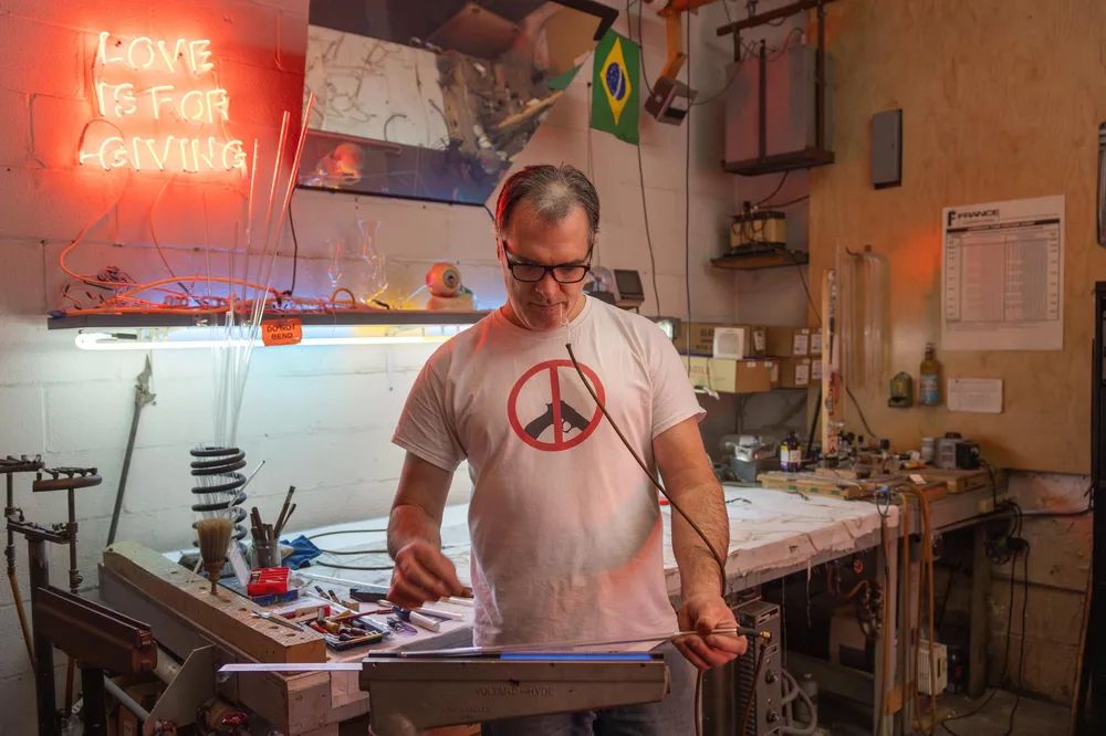 A man making a neon glass sign.