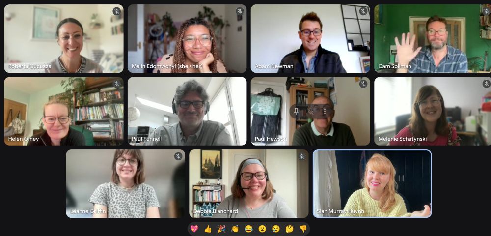 11 smiling faces on an online call
