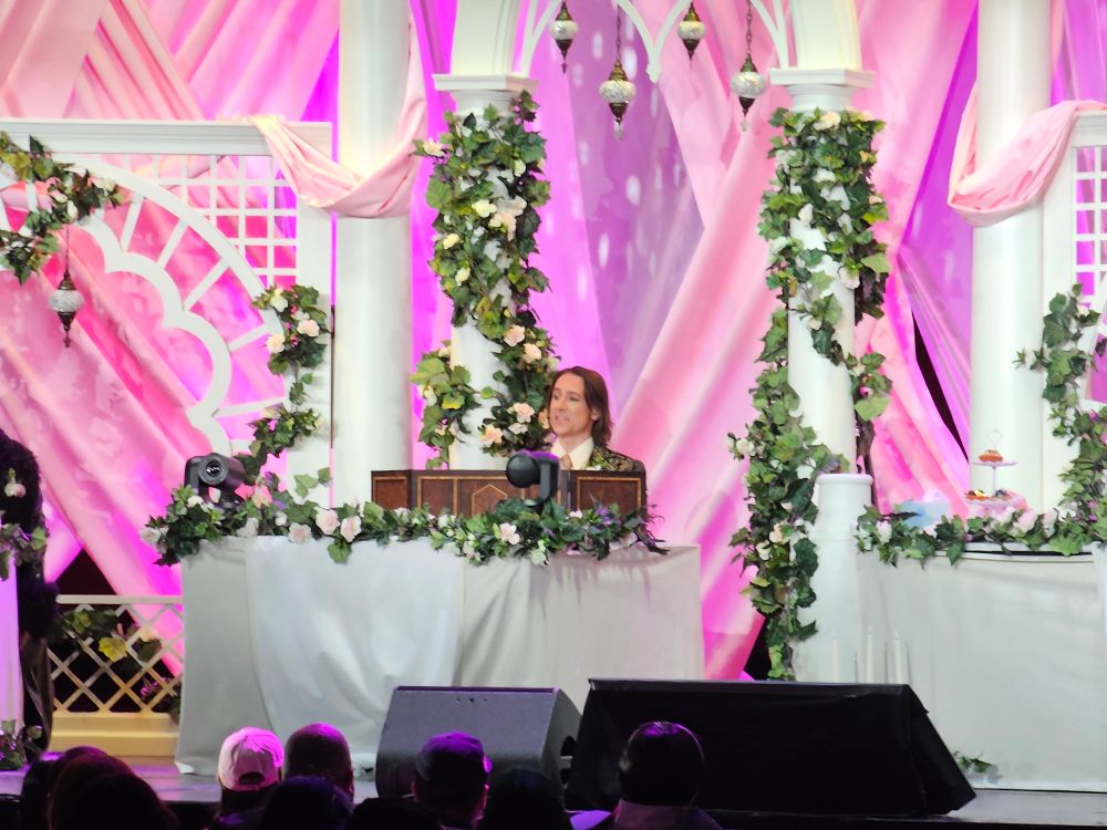 Matthew Mercer sitting behind his DM screen on stage at Radio City Music Hall