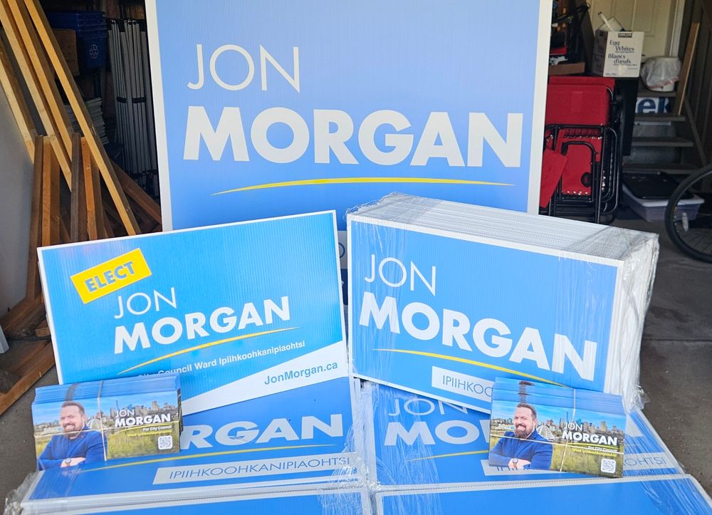 Jon Morgan for Edmonton City Council in Ward Ipiihkoohkanipiaohtsi lawn signs and literature displayed.
