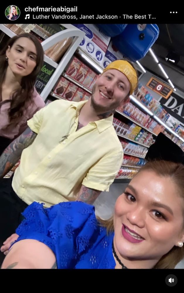 Chef Abbie on the set of Guy's Grocery Games with two chefs behind her