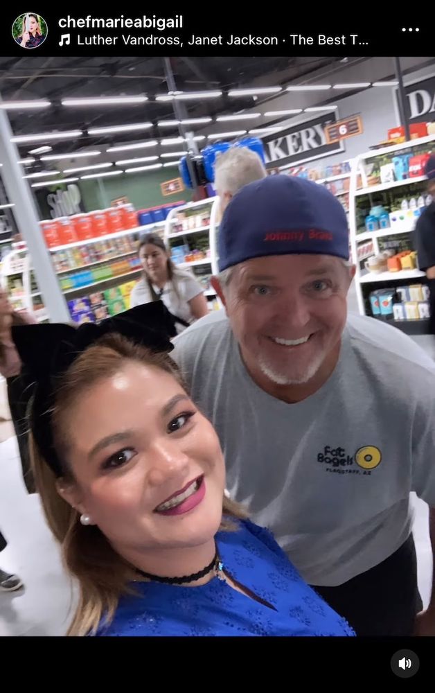 Chef Abbie on the set of Guy's Grocery Games taking a selfie with a smiling man in a hat
