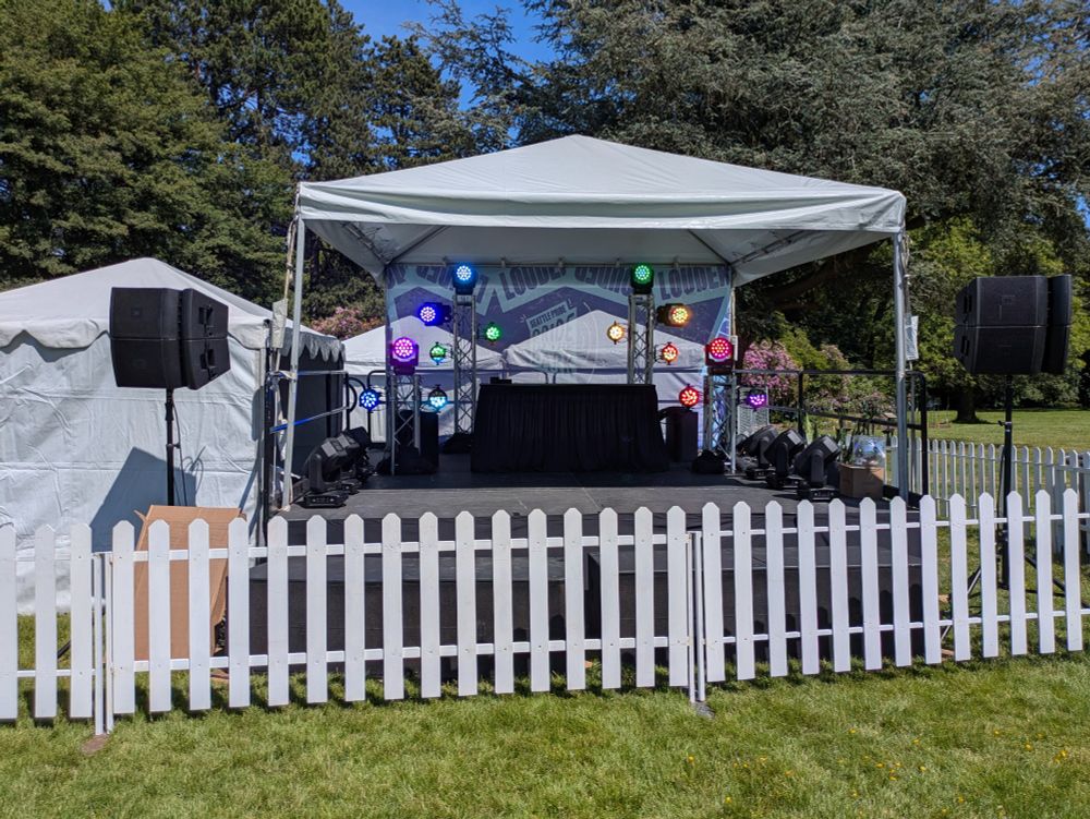 A photo of a stage with lights displaying a rainbow.