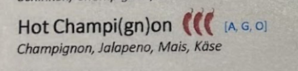 Screenshot aus einer Speisekarte: Hot Champi(gn)on mit Champignon, Jalapeno, Mais, Käse