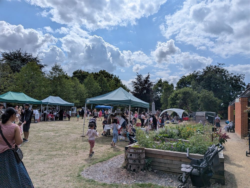 Lots of people, families, and kids in the museum garden.