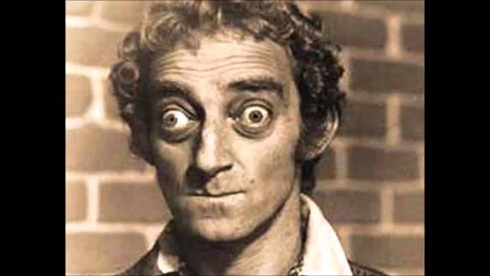 Black & white image, centered, of actor Marty Feldman, known for uncrossing his eyes so they're both looking outward, usually for comedic effect.