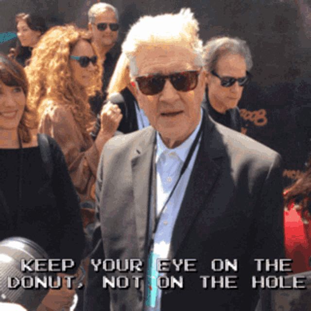 Picture of David Lynch wearing sunglasses with the caption "Keep your eye on the donut, not on the hole"