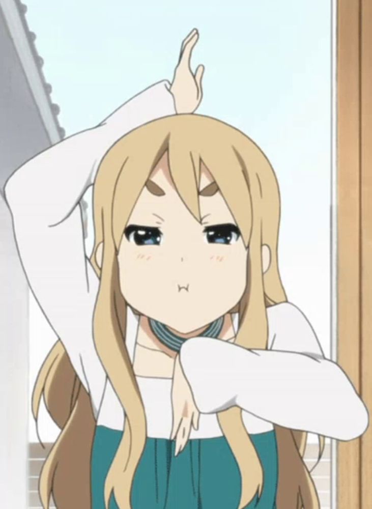 a blonde anime girl is making a funny face with her hand up