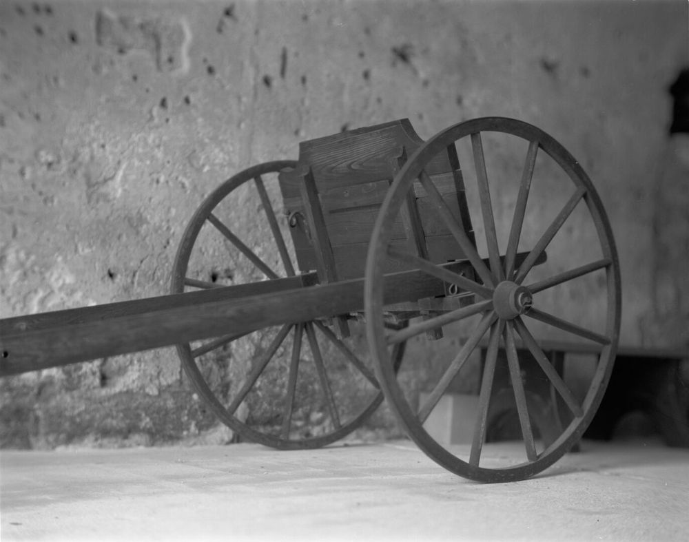 A wooden cannon carrier sits inside the fort.