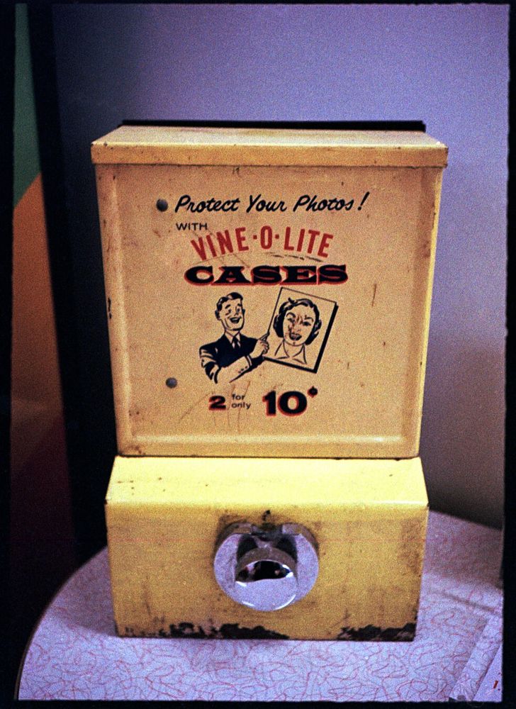 An aging yellow steel box with the words “Protect Your Photos! With Vine-O-Lite Cases 2 for only 10¢"