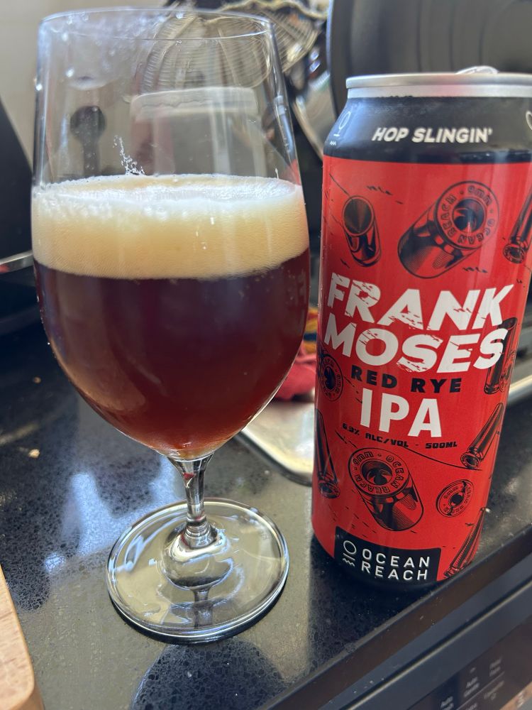 A can of Frank Moses, Red Rye IPA, beside a glass containing said liquid.