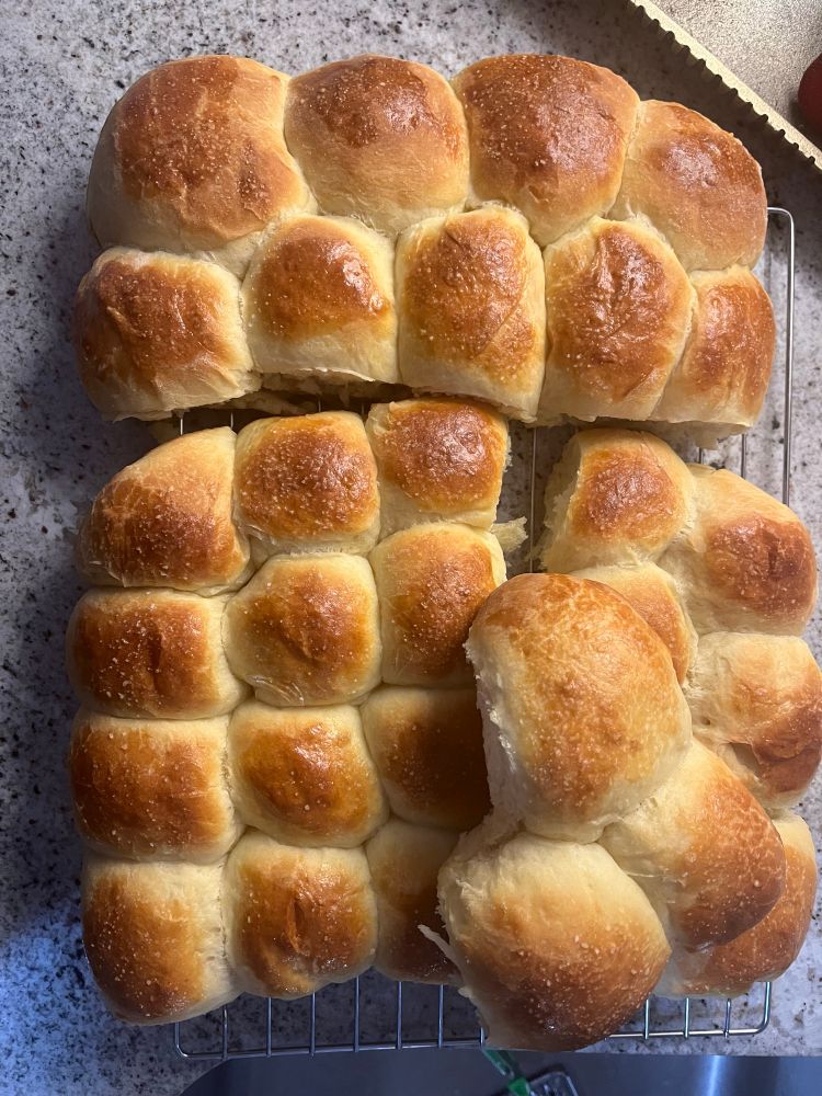 Homemade, buttery, garlicky pull apart rolls cooling on a wire rack.