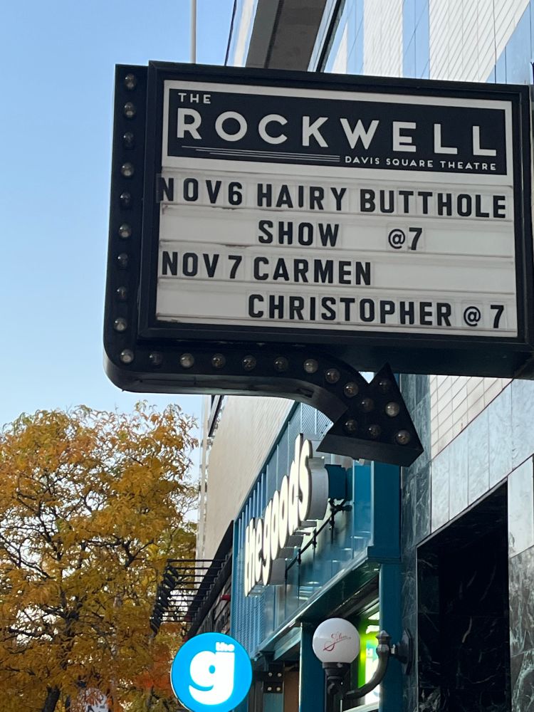 A show marquee featuring two bands: Hairy Butthole and Carmen Christopher, in Somerville, MA.