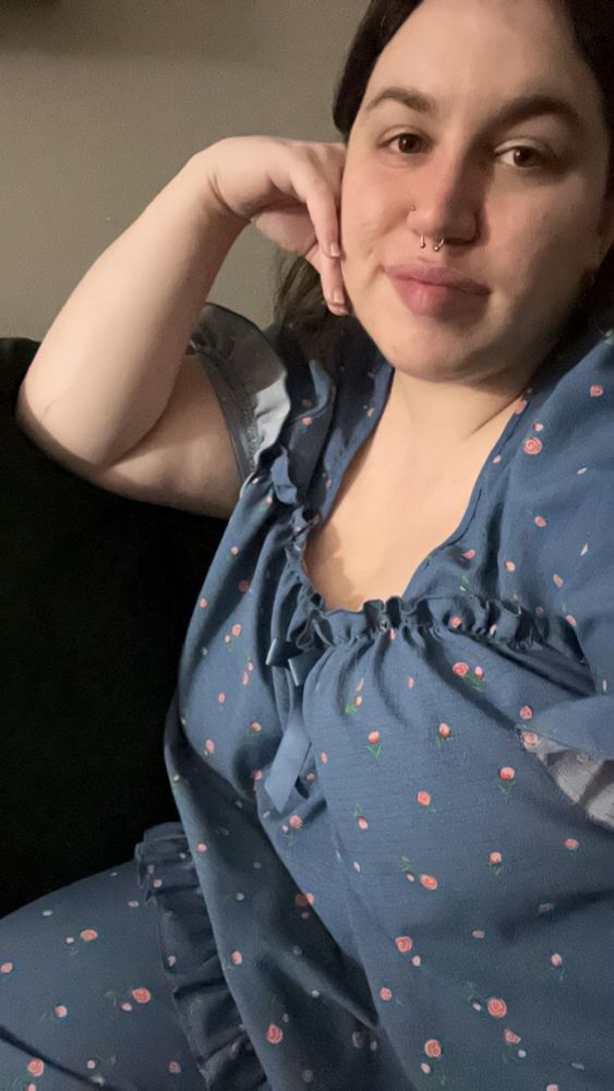 Selfie of me, wearing blue frilly pajamas with little pink flowers all over