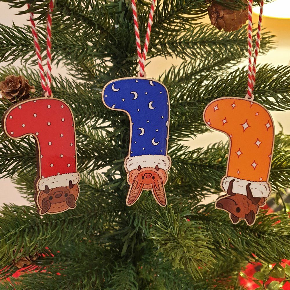 Photo of three bats in stockings hanging out on a Christmas tree - they are cute and smiling!