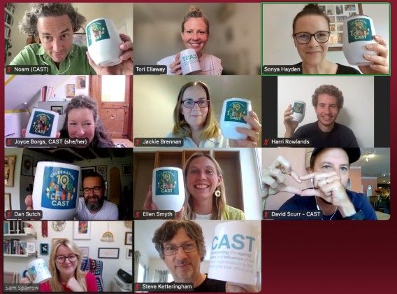 An image showing the 11 people in the CAST team (six women and five men) holding up their CAST 10th anniversary mugs.
