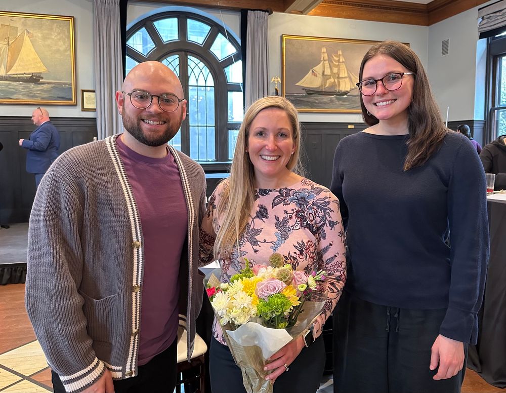 Photo of three people, from left to right is myself Patrick, then Dr. Hughto holding flowers, then Amelia, another PhD candidate in my program who is mentored by Dr. Hughto.
