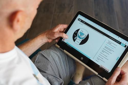 Doctor using a tablet to work through PCUK e-learning modules. 