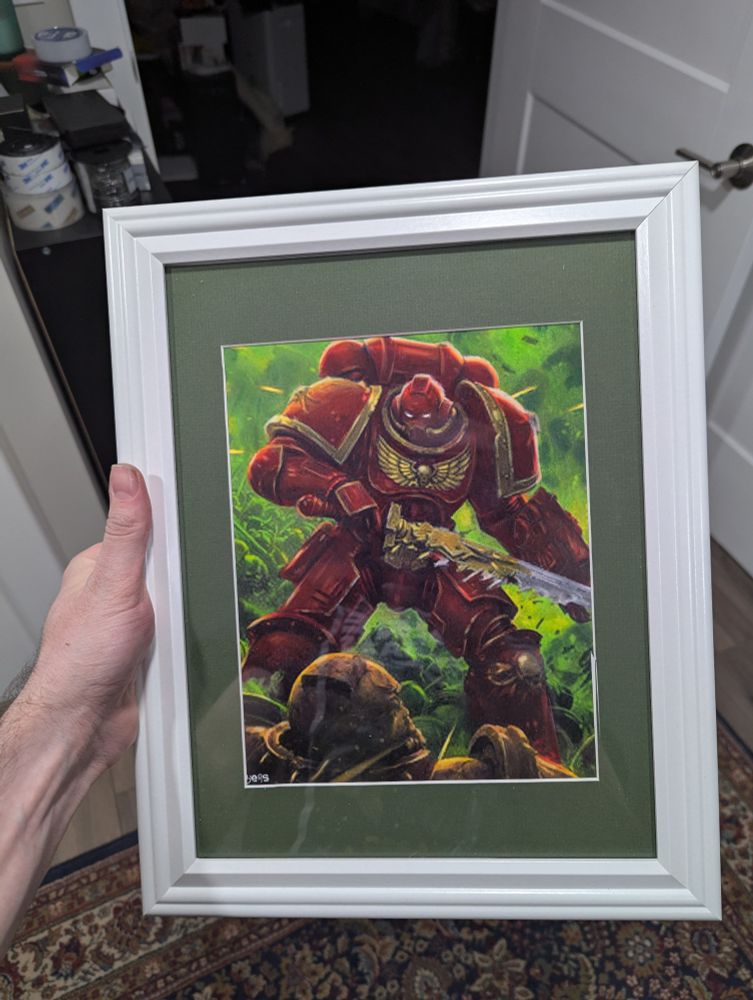 A framed drawing of a blood angel space marine 
