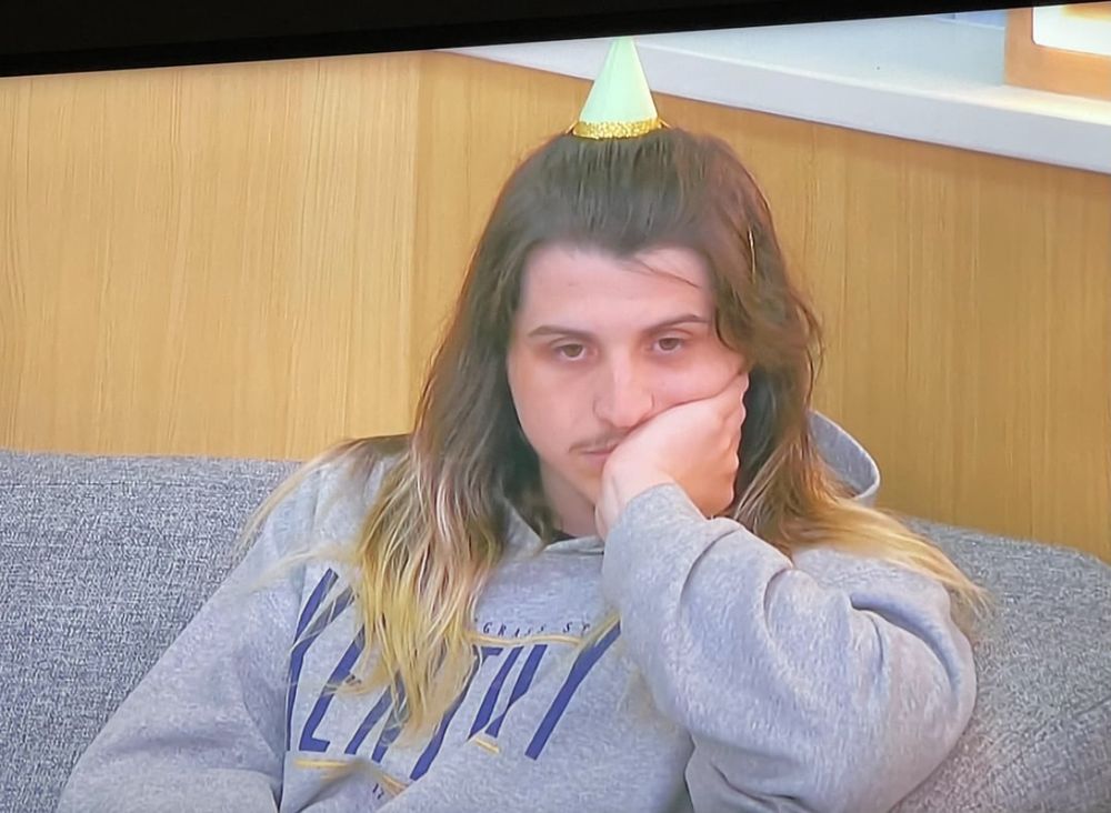 Turner in a tiny bday hats giving his best festive scowl