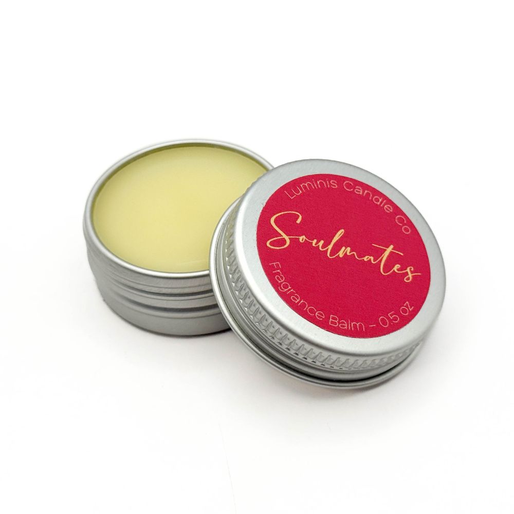A small silver tin containing a pale yellow balm. The lid has a label that reads "Soulmates".