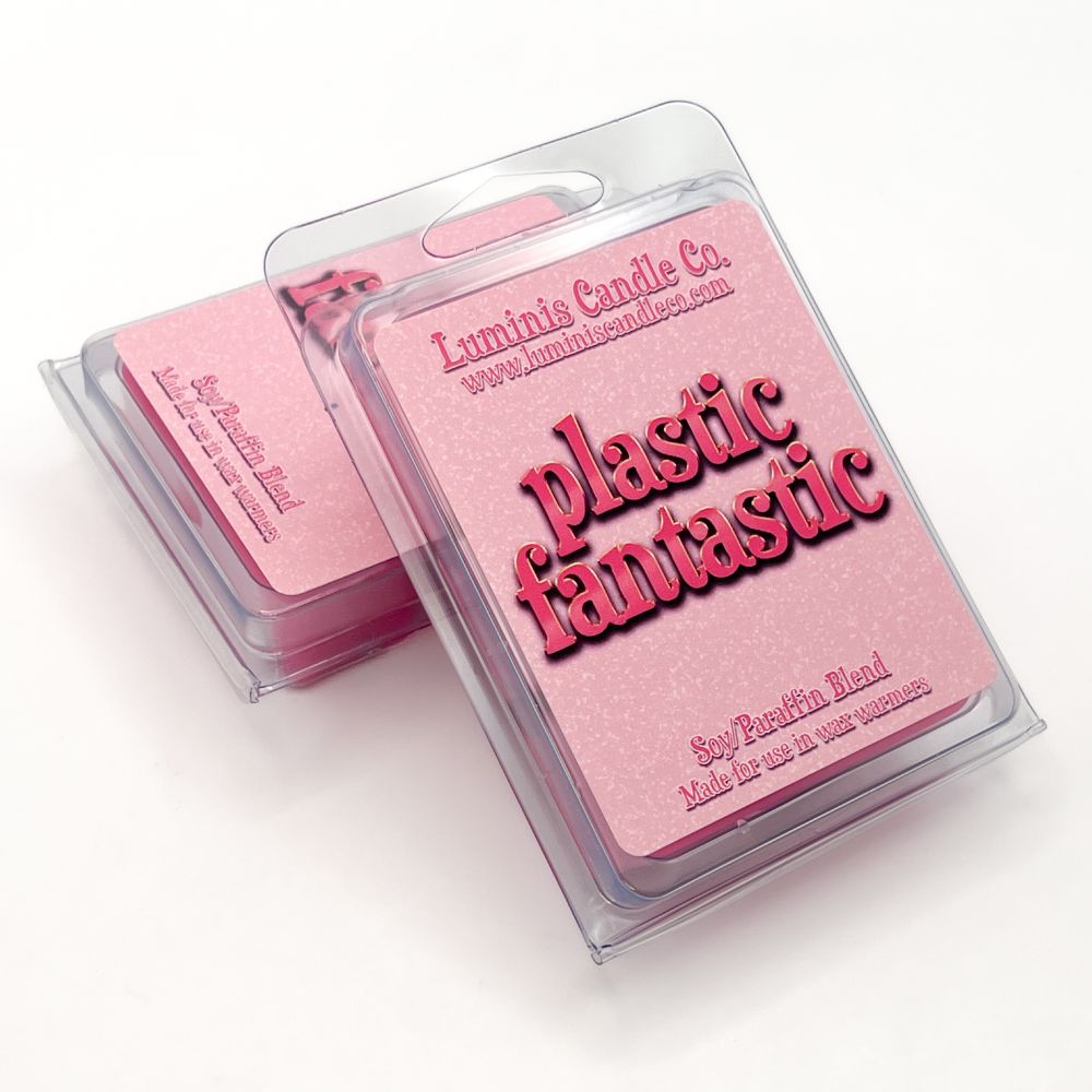 A pair of wax melts with one propped up in front of the other. The melts in front show the label, which says the scent name: "Plastic Fantastic".