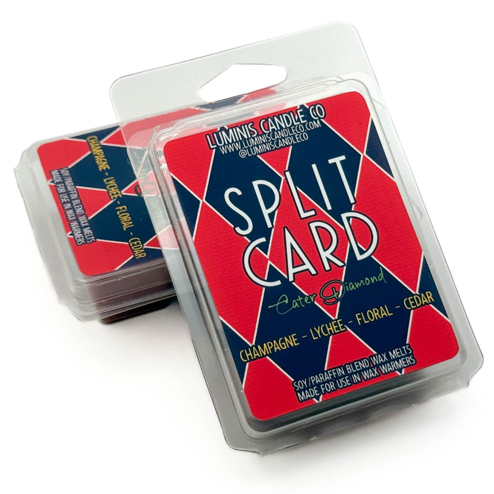 A wax melt propped up against another wax melt, both with labels that say the scent name, Split Card.