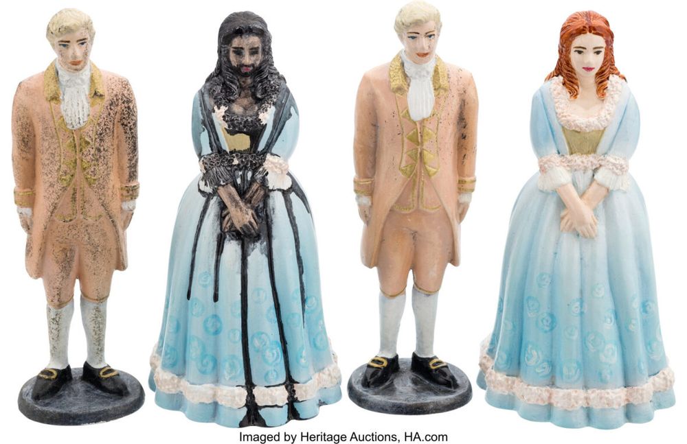 the wedding cake toppers that blackbeard paints to look like him. and then i guess his barbie scissored the ken/stede because the blonde guy is a bit blackened too. the breasts are more pronounced on his version than they are on the original bride. from the ofmd auction happening here (if you're wealthy and reading this please get me a present love you): entertainment.ha.com/itm/movie-tv-memorabilia/memorabilia/our-flag-means-death-max-r-original-2022-2023-taika-waititi-blackbeard-4-wedding-toppers-from-season-2-episodes-1-/a/41193-4124.s?ic4=GalleryView-ShortDescription-071515