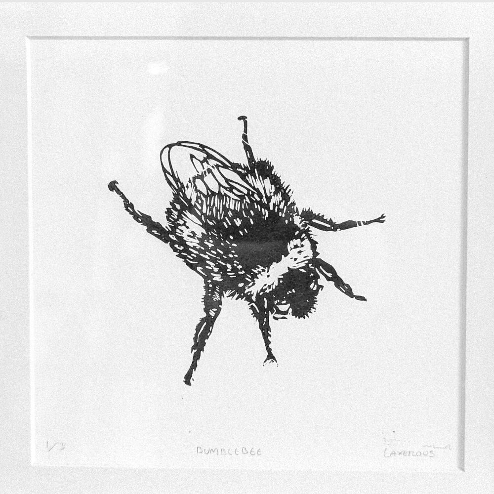 A lino printed artwork of a bumblebee in black and white
