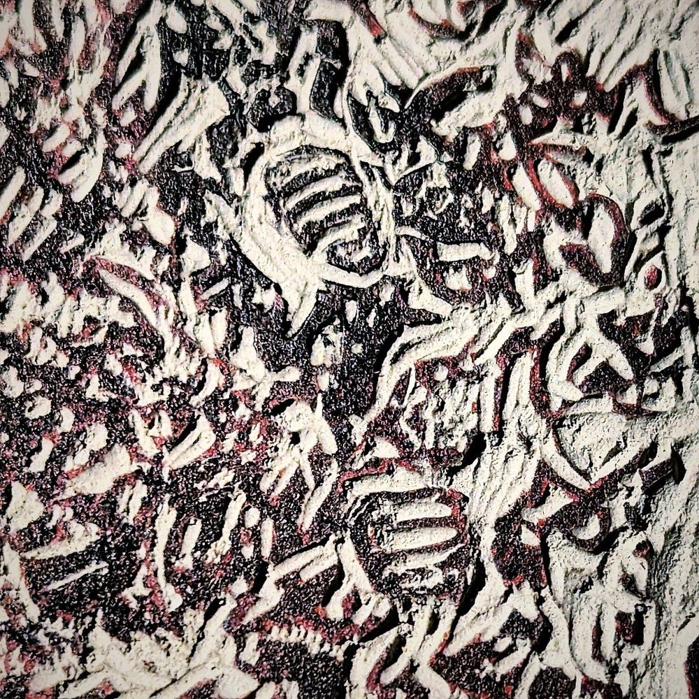 Close up of the lino cut fishy design border of sand details