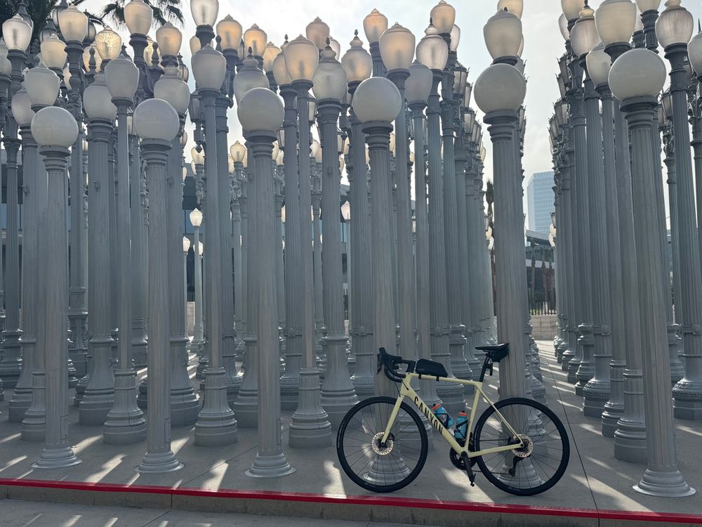 A yellow Canyon Endurace road bike leans against “Urban Lights” a collection of restored Los Angeles street lamps.