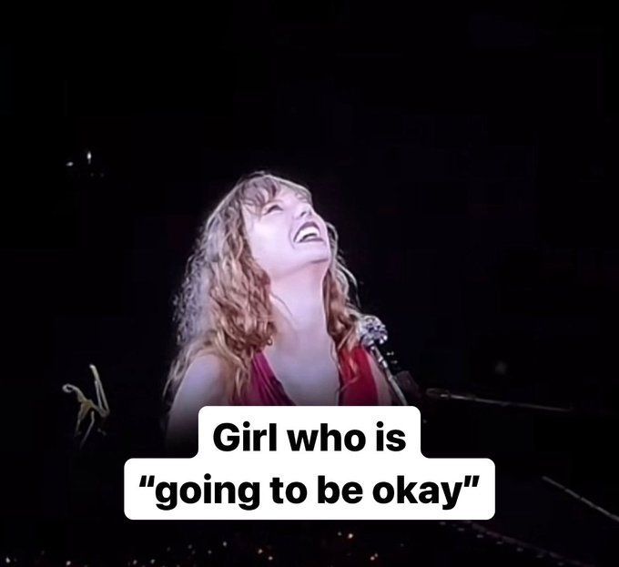 taylor swift seated at the piano at the eras tour. her face is tilted up so she's looking at the sky, and she's smiling so big and full of joy. text is edited on top: Girl who is "going to be okay". 