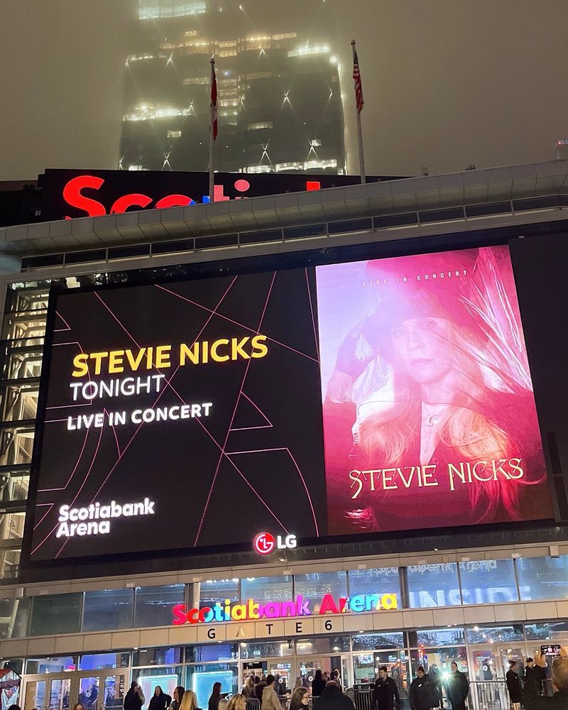 giant billboard outside scotiabank arena advertising tonight's stevie nicks show, featuring a red-hued photo of her in her iconic black hat. 