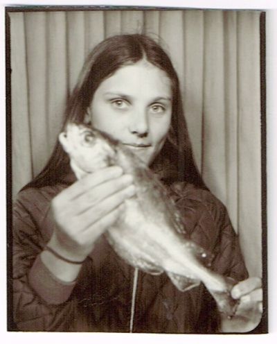 girl in photo both, she is holding a fish