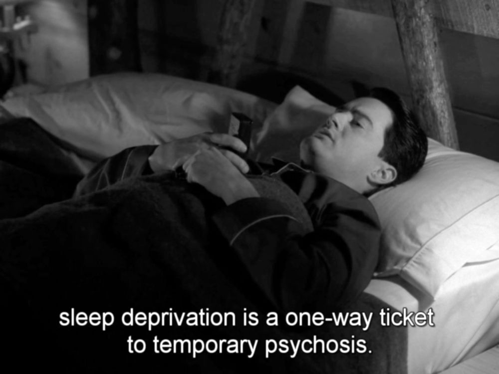 man lying down, talking into a small tape recorder
sleep deprivation is a one-way ticket to temporary psychosis.