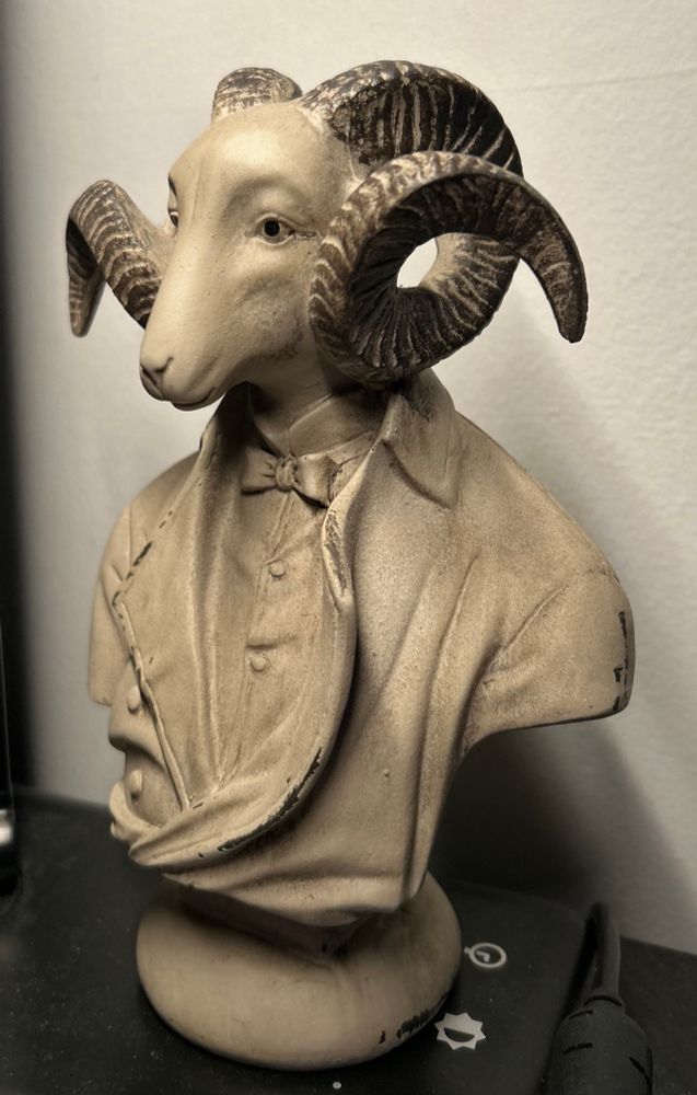 Dapper attired goat head individual 