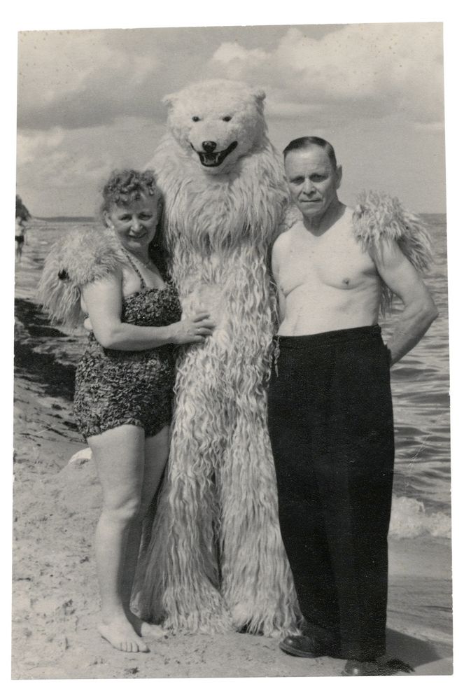 topless man and woman in a swinsuit posing with a bloke in a bear suit