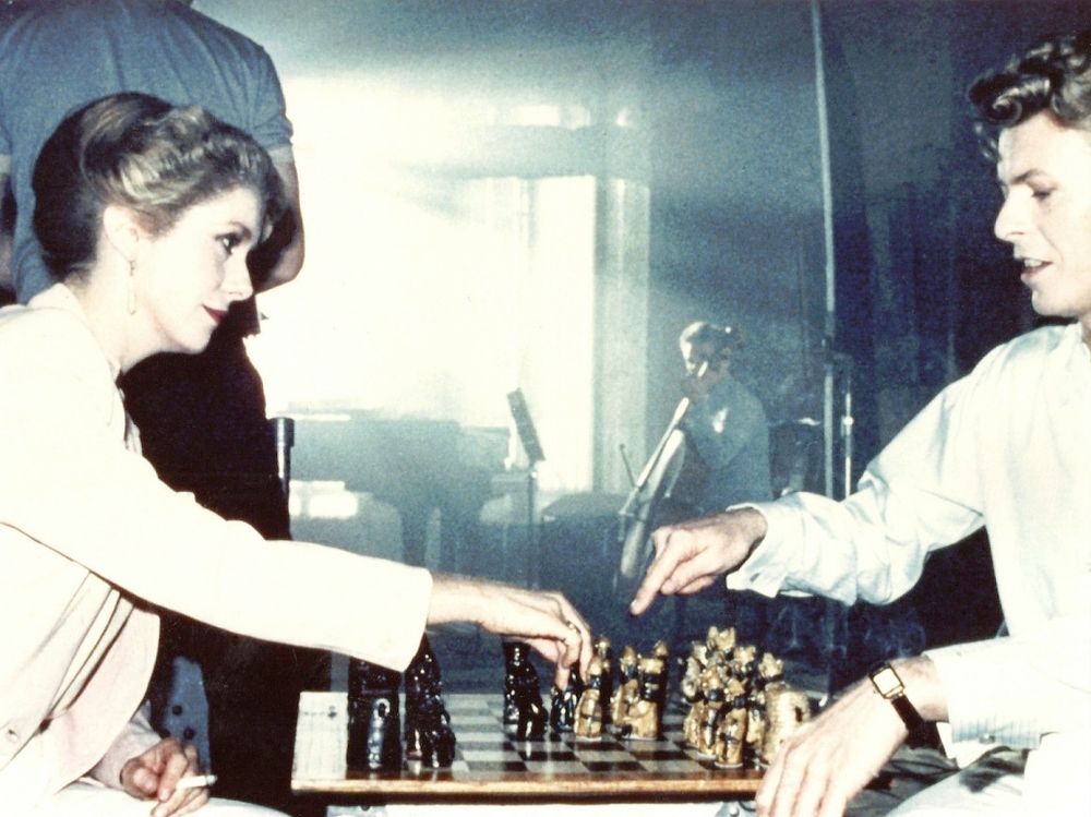 woman and man playing chess