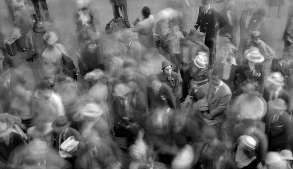 long exposure film show one person stood still amongst a bustling scene