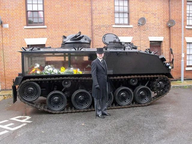 armoured vehicle converted to a hearse, with glass sides to view the coffin.