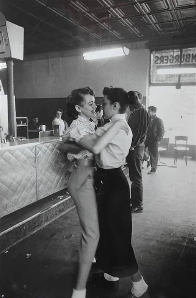 two women dancing closely and smiling at each other