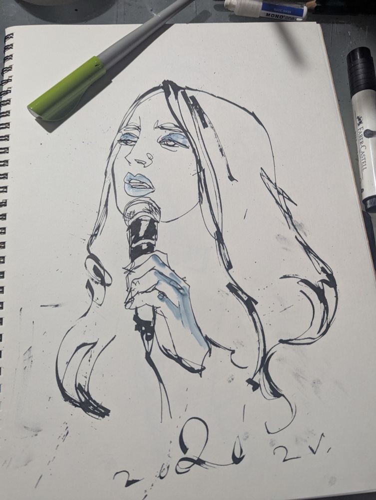 Fern holding a mic, doing comedian stuff