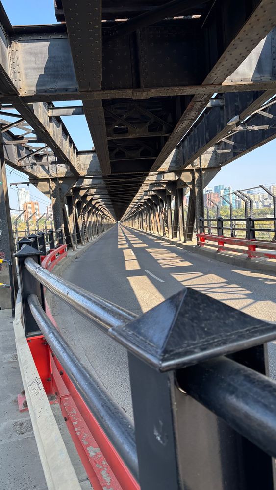 High Level Bridge with no vehicles in the driving lanes. A collision can be seen way on the other side at the entrance